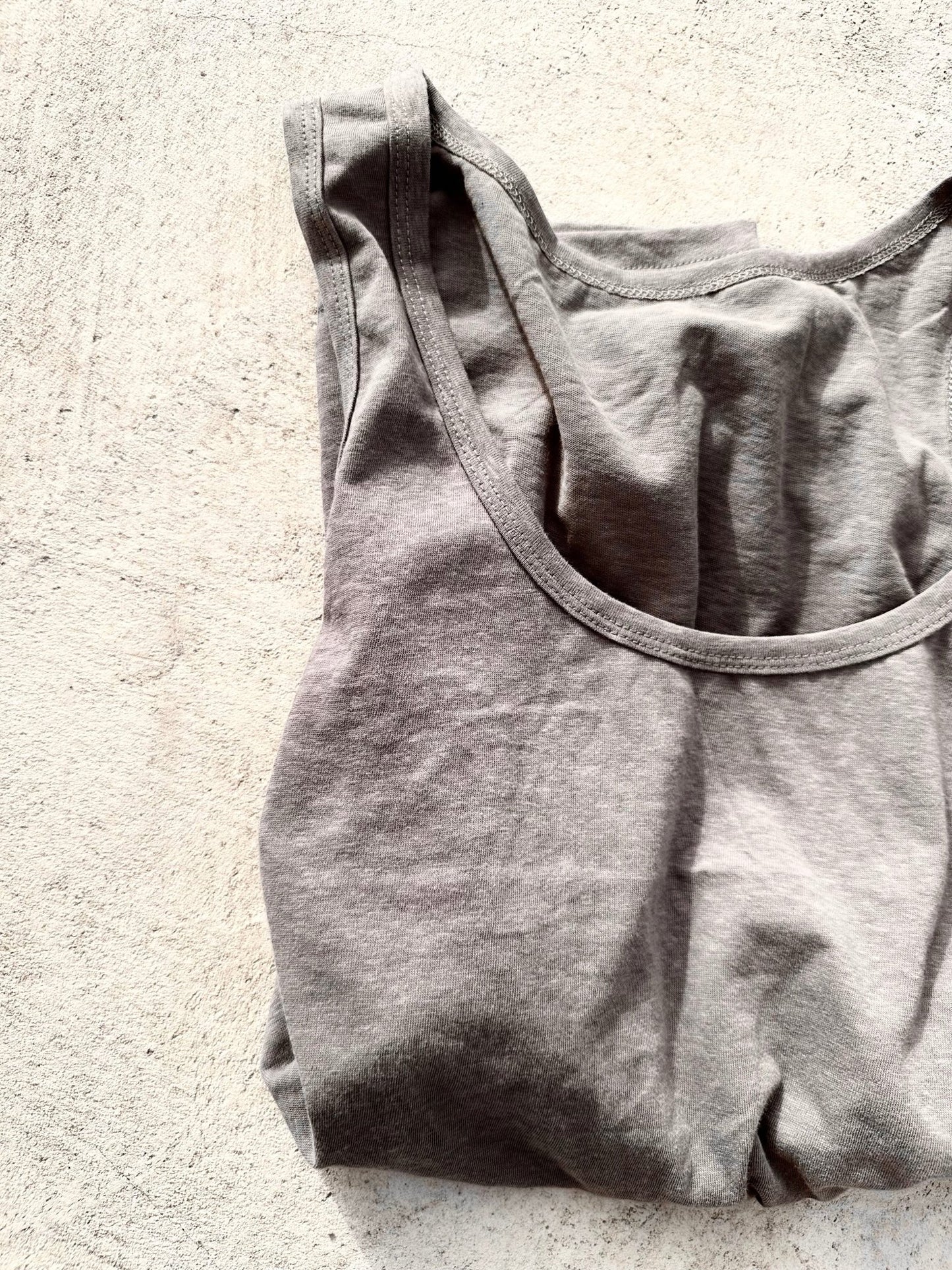 Dark grey tank top on the ground