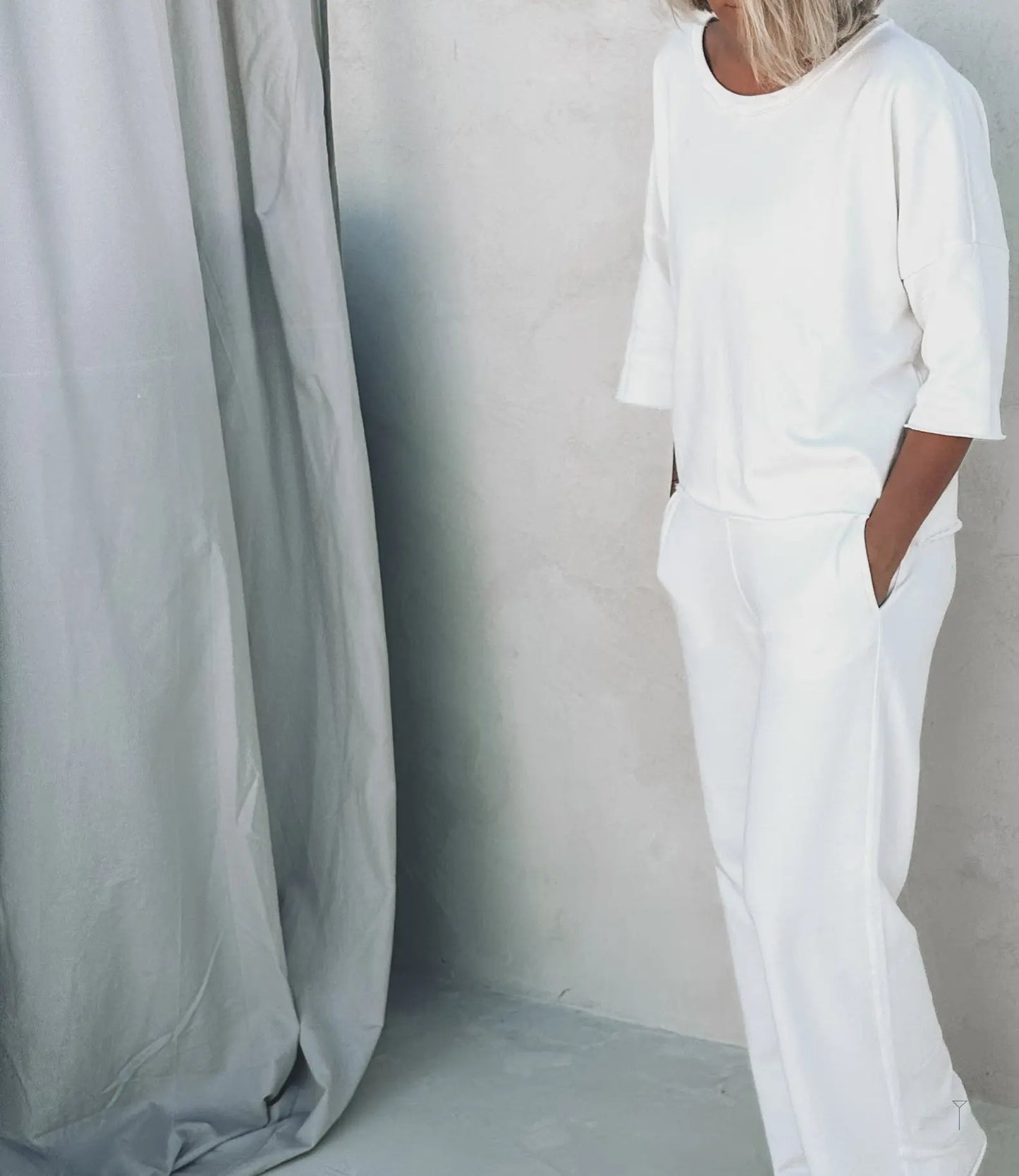 A woman wearing basic white lounge set from Tulua
