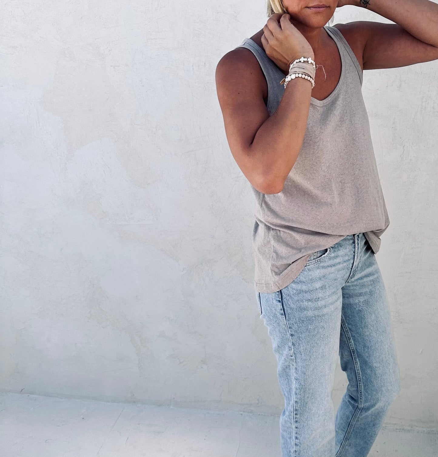 A woman posing for a picture in a tulua tank top.