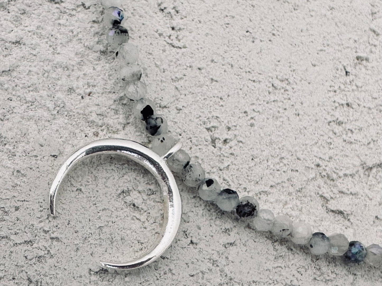 Tulua silver moon and stone necklace.