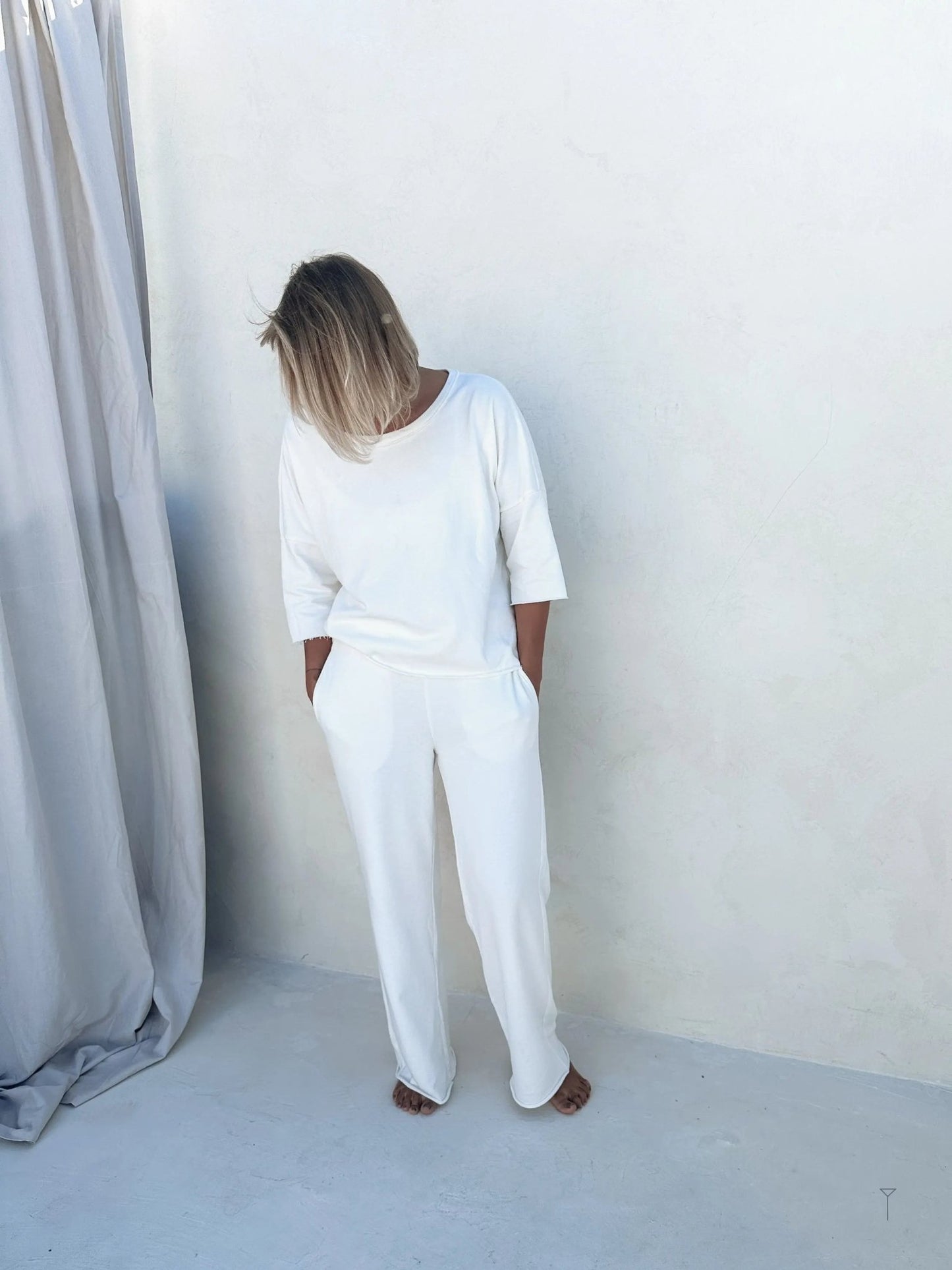 A woman with a comfortable white pants and hoodie