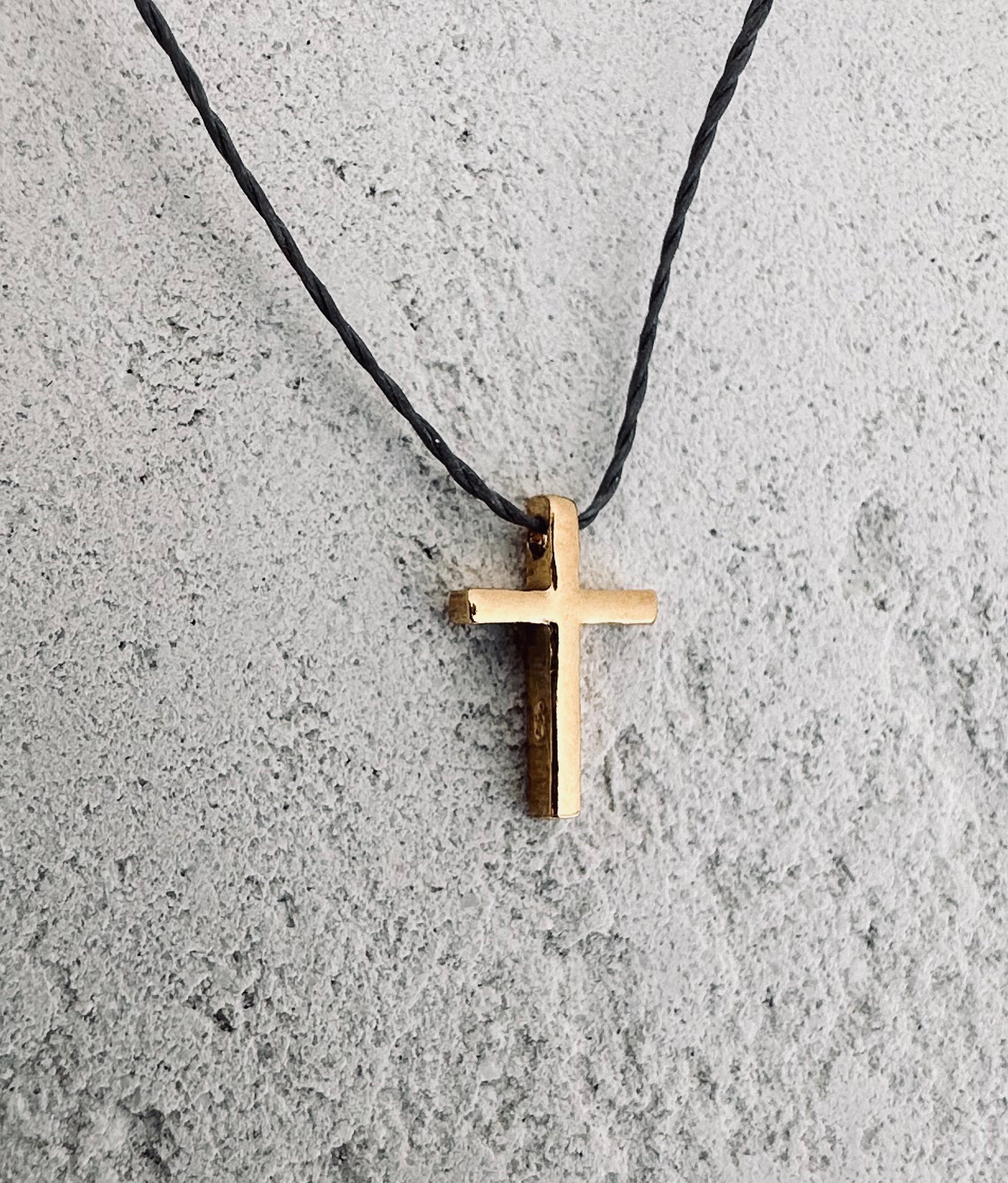Simple gold cross on the cord. 