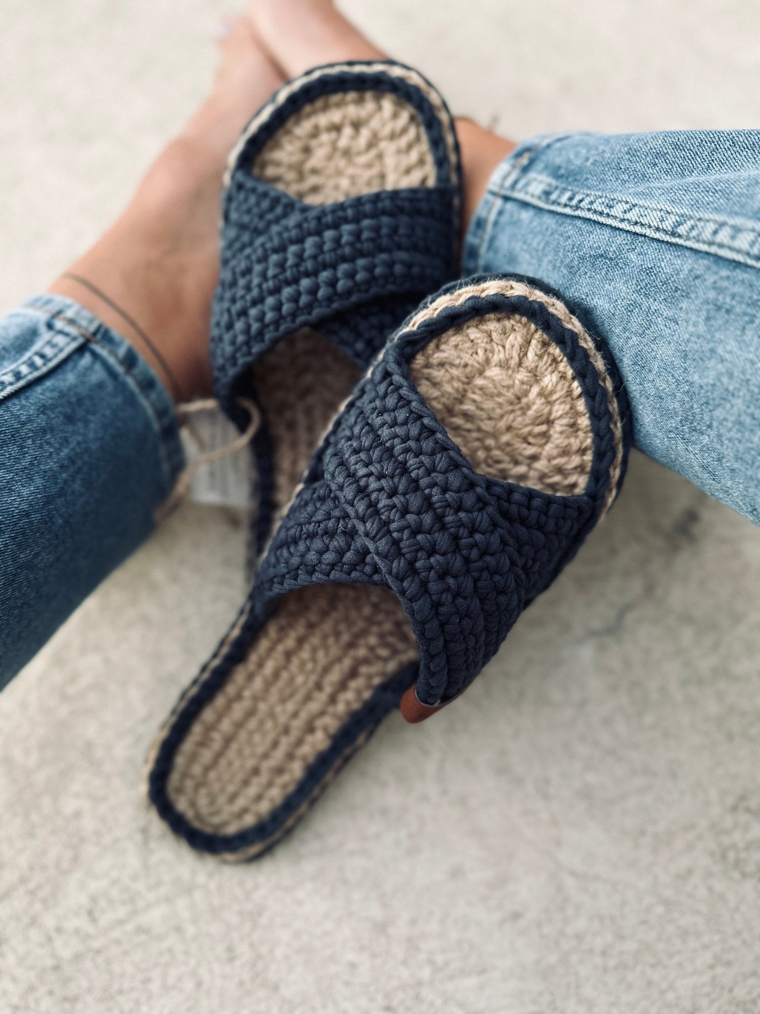 Blueberry color flats crossed on women’s legs