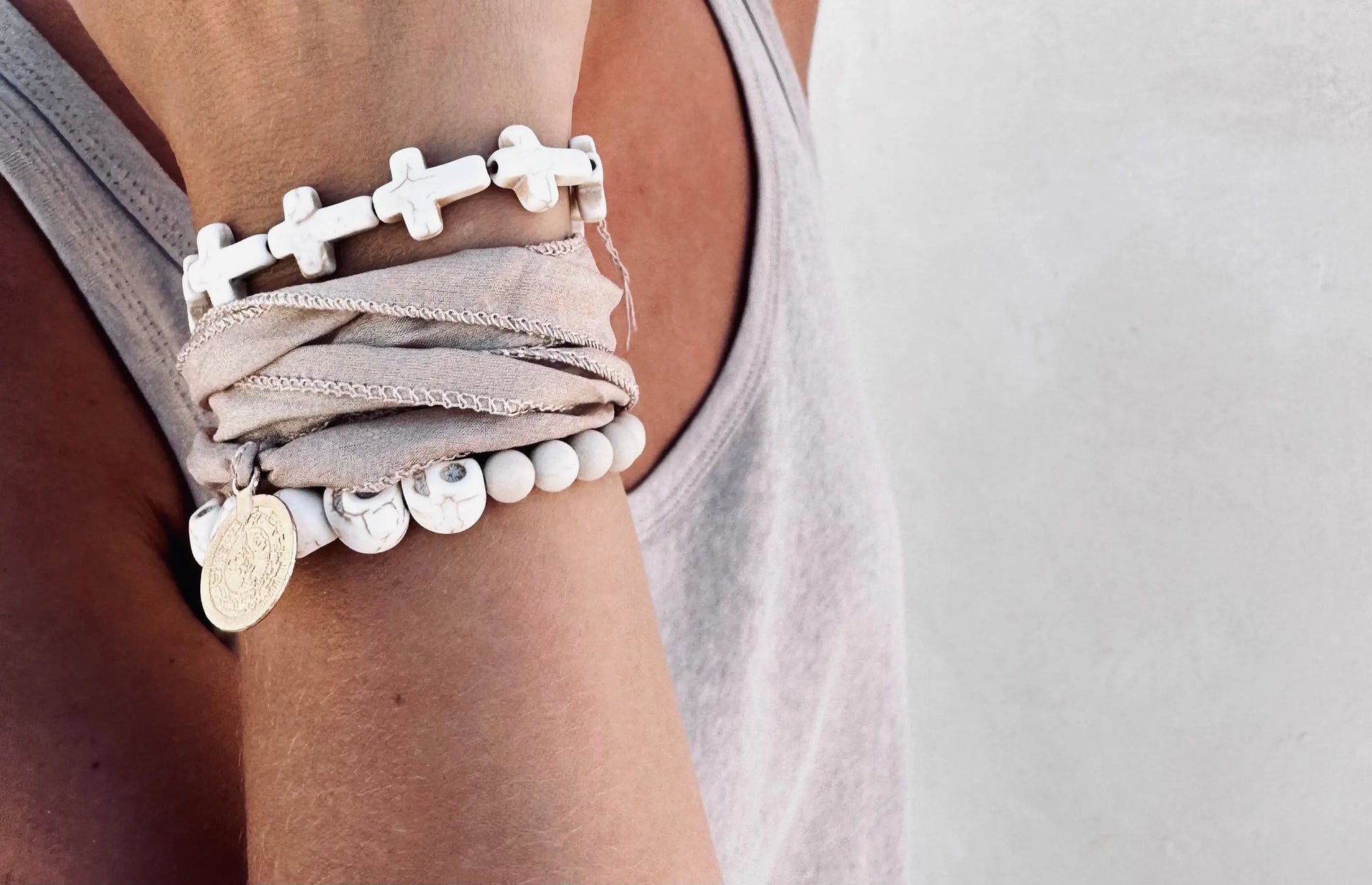 A women wearing silk bracelet with a coin on it. 