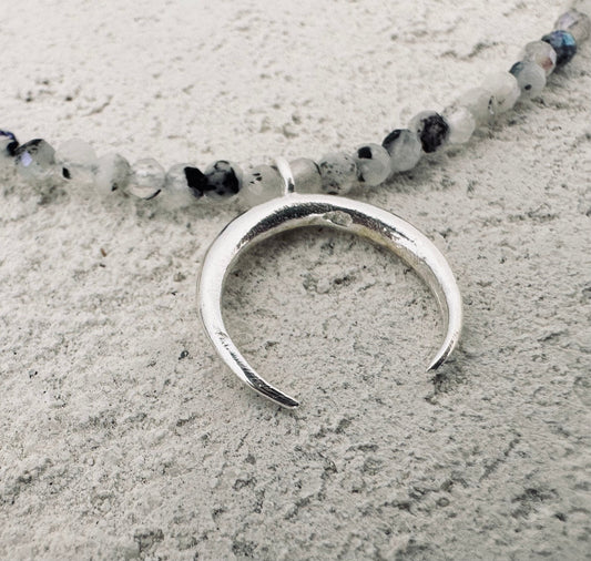 Silver moon necklace with a small stones. 